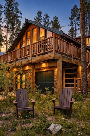 A cabin with a wooden deck and two Adirondack chairs in front. - Lakeview Retreat Walk to Town + Fenced Yard (Grand Lake)
