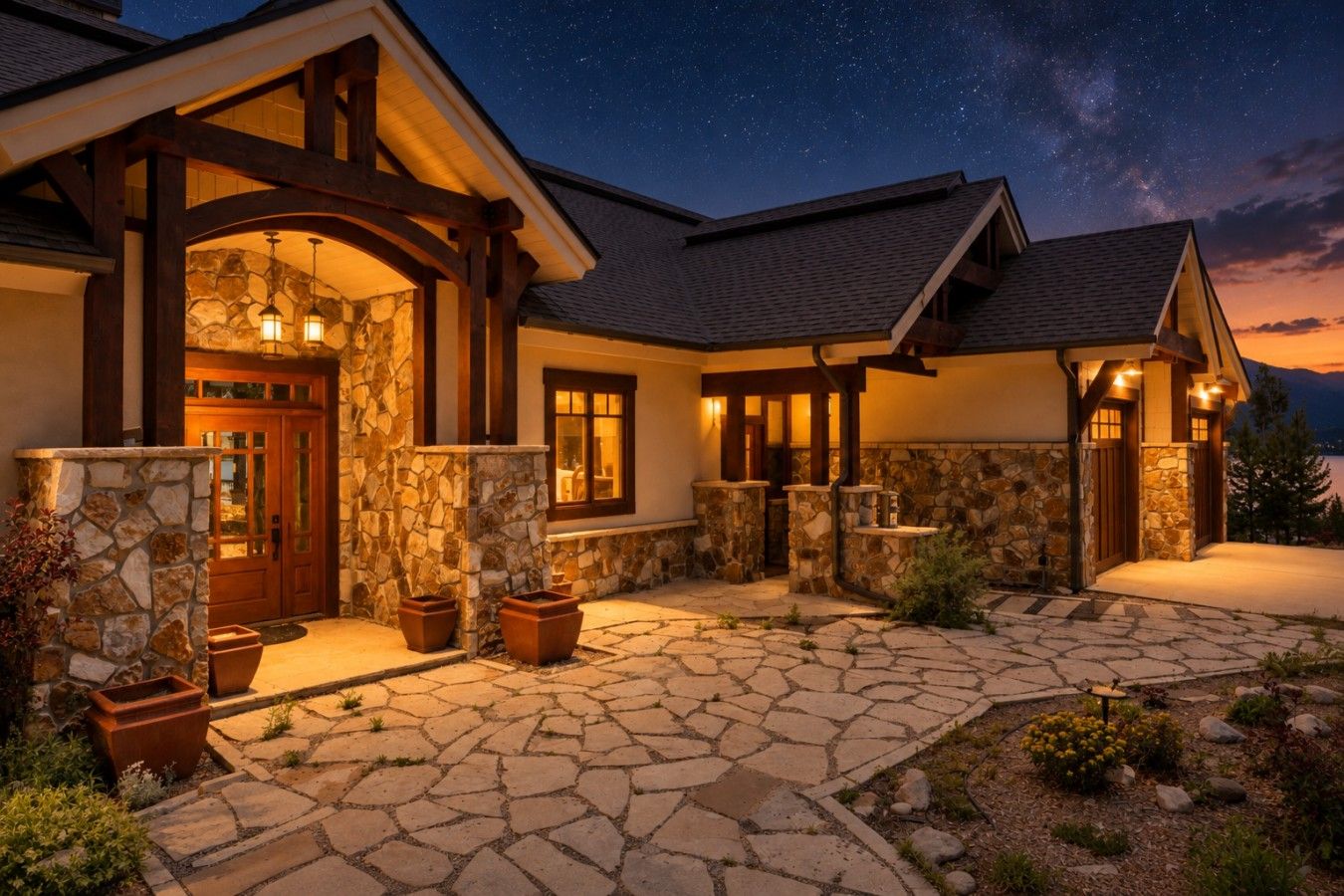 A stone-clad house with a stone entrance, multiple windows, and a starry night sky.