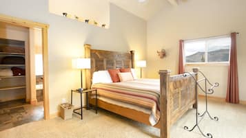 Un dormitorio con cama de madera, lámparas de noche, ventana con vistas y armario empotrado.
