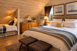 A bedroom with a large bed, a smaller bed, a dresser, a bench, and a window with curtains. - Downtown luxury retreat, Lake and MTN views, Yoga (Grand Lake)