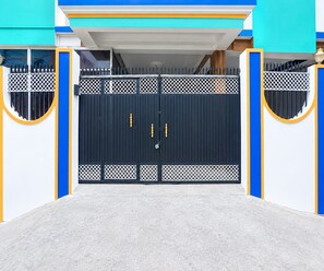 A gated entrance with a metal gate and a keyhole lock.