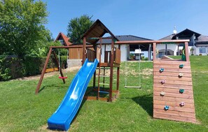 A playground with a blue slide and climbing wall. - Stunning home in Sveti Martin na Muri with sauna (Sveti Martin na Muri)