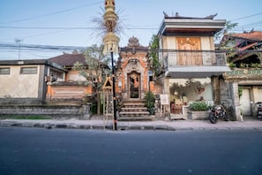 A traditional building with a staircase leading to a door, a balcony, and a motorcycle parked outside. - Quiet Balinese Stay in Ubud (Gianyar)