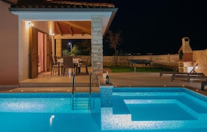 An outdoor swimming pool with a stone pillar, a covered patio area, and a brick oven. - Lovely home in Kavran with private swimming pool, can be inside or outside (Kavran)