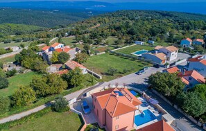 A residential area with houses, a swimming pool, and a view of the surrounding landscape. - Lovely home in Kavran with private swimming pool, can be inside or outside (Kavran)