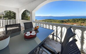 A terrace with a table set for two, overlooking a coastal landscape. - Gorgeous apartment in Klenovica with house sea view (Klenovica)