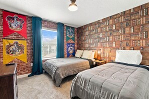 A bedroom with two beds, a brick wall, and a bookshelf. - Magical Getaway With Private Pool, Top Location (Davenport)