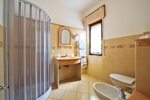 Ein Badezimmer mit Dusche, Waschbecken und Toilette.