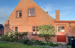 A red brick house with a gabled roof, a front door, and a chimney. - 3 bedroom amazing home in Fanø (Fanø)