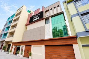 A multi-story building with a prominent 'Collection' sign, large windows, and a garage door.