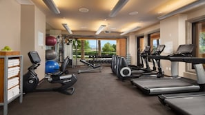 Ein modernes Fitnessstudio mit Laufbändern, Kraftgeräten und Kurzhanteln.