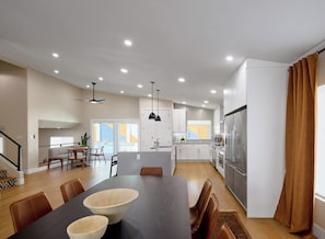 A modern kitchen with a central island, white cabinetry, and stainless steel appliances. - Sundance - Private Pool - Mins to Kierland Commons (Scottsdale)