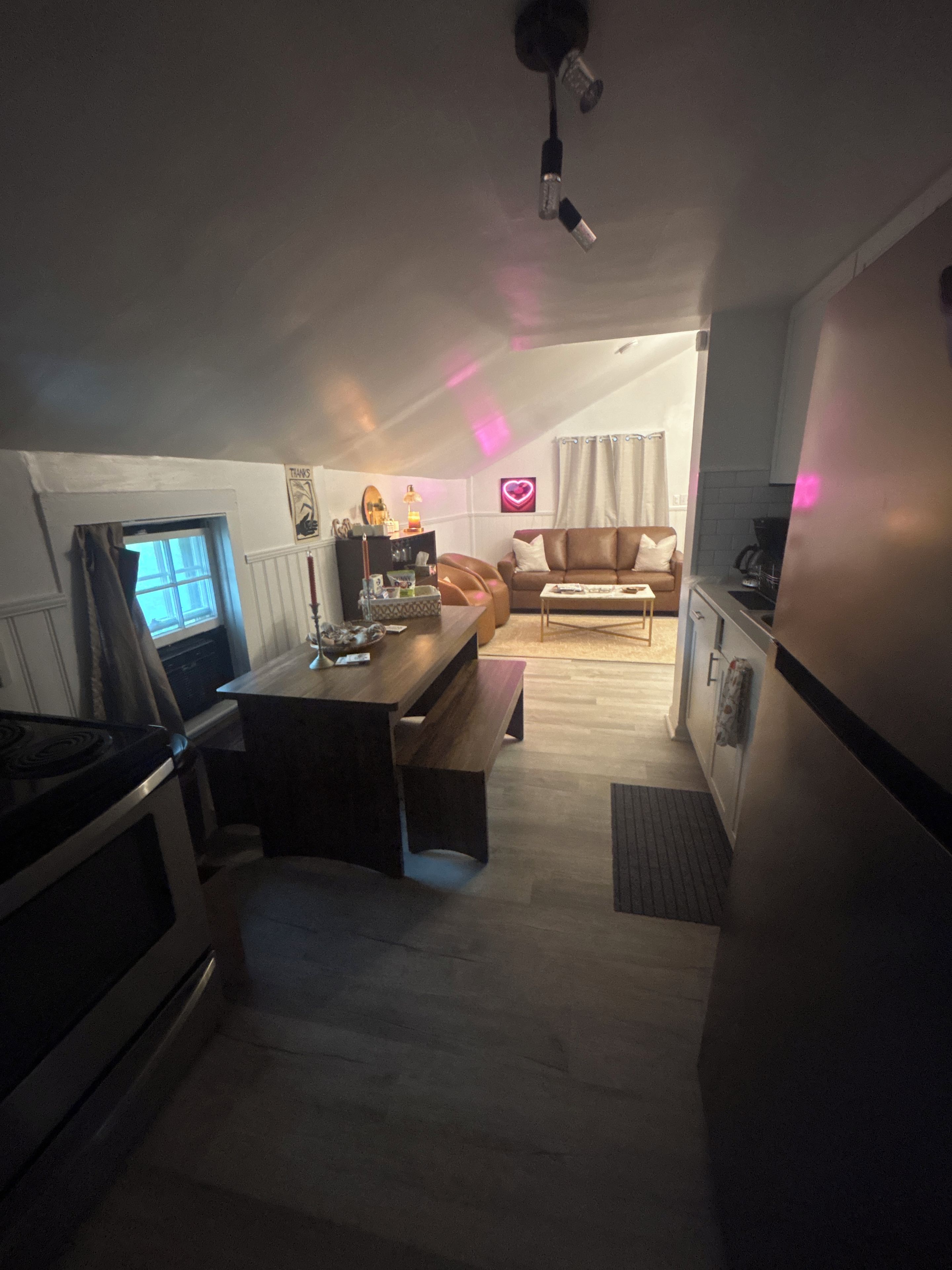 A compact living space with a kitchenette, a dining area, and a seating area.