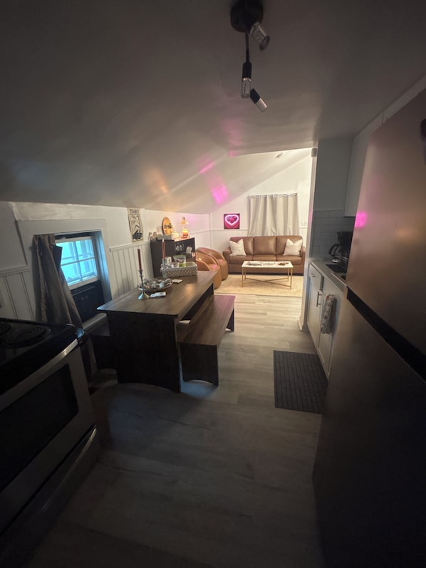 A compact living space with a kitchenette, a dining area, and a seating area.