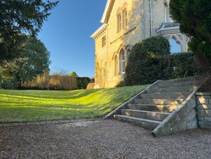 A building with a stone facade, a set of stone stairs leading up to the entrance, and a well-maintained lawn. - Eden Mount, Wetheral -  a cottage that sleeps 10 guests  in 5 bedrooms (Wetheral)