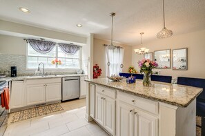 A spacious kitchen with white cabinets, granite countertops, and a central island. - Spacious 5BR Home for Families & Groups (Fort Washington)