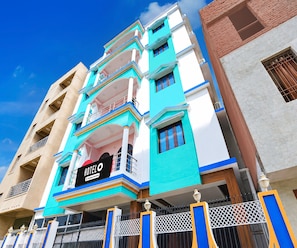A multi-story hotel with a prominent sign indicating it is a company-serviced hotel.