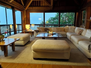 A cozy living room with a sectional sofa, a coffee table, and a wooden floor.