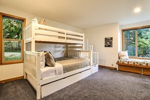 A bunk bed with storage drawers, a window with a view of greenery, and a bench with a cushion. - Water & Gulf Islands Views, Beach Access, Hot Tub, Game Room (Bellingham)