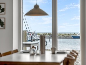 A dining area with a view of boats and a pier. - "Jela" - 10m from the sea by Interhome (Glesborg)