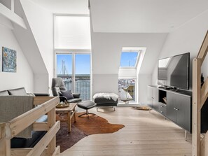 A modern loft bedroom with a large skylight, a television, and a view of the sea. - "Jela" - 10m from the sea by Interhome (Glesborg)