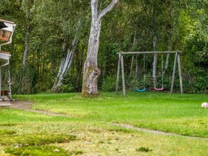 A grassy area with a swing set and a tree. - "Aisa" - 200m from the sea by Interhome (Ebeltoft)