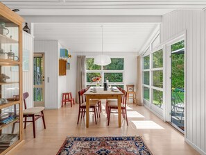 A spacious dining area with a large table, multiple chairs, and a patterned rug. - "Aisa" - 200m from the sea by Interhome (Ebeltoft)