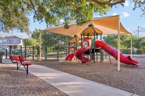A playground with slides and a bench. - 4BR Home with Pool and Firepit Near SanTan Village (Gilbert)