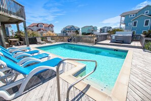 A pool area with lounge chairs and a wooden deck. - Semi-Oceanfront- Private Pool, Hot Tub-OH1200, Spyglass (Corolla)