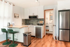 A compact kitchen with a microwave, sink, and stainless steel refrigerator. - Fully Renovated, King Bed, Dog Paradise, 4-Acres (Sidney Center)