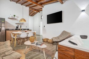 A modern living space with a kitchen, dining area, and seating area. - Walkable Provenza Apt Jacuzzi (Medellín)