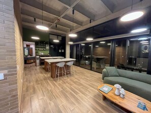 A modern interior with a bar area, seating, and a sofa. - El Retiro Design Forest Panoramic View (Retiro)