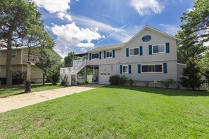 A two-story building with a covered porch and a basketball hoop. - Carefree - 5 BR north end home with Lake Tecumseh access (Virginia Beach)