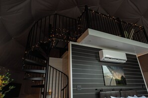 A spiral staircase with a modern design, an air conditioning unit mounted on the wall, and a framed picture of a landscape. - Geodesic Dome w/ HotTub 4 mi to Seneca Rocks (Seneca Rocks)