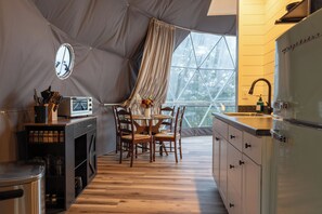 A compact kitchen with a dining area, a large window, and a view of trees. - Geodesic Dome w/ HotTub 4 mi to Seneca Rocks (Seneca Rocks)