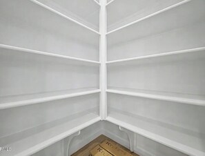 A corner of a room with white shelves and a wooden floor. - Fantastic 4-bedroom house with AC in sunny Phoenix (Phoenix)
