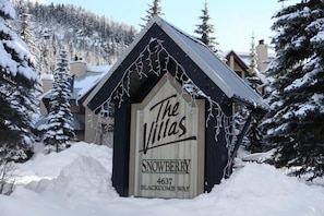 A wooden cabin with a sign reading 'The Villas' and 'Snowberry 4637 Blackcomb Way.' - New Listing | Beautifully Updated 3BR | Close to Village & Lost Lake | Managed By Aloha Whistler (Whistler)