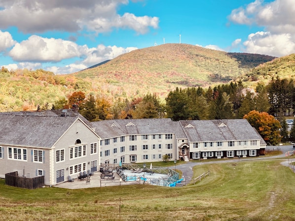 A large building with multiple windows and a swimming pool area.