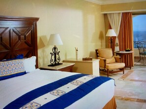 A hotel room with a large bed, a chair, a desk, and a view of the outside. - 2BR/2B Presidential Suite at Pueblo Bonito Sunset with Exclusive Butler Service (Cabo San Lucas)