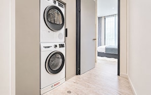 A modern hotel room with a Bosch washing machine, a bed, and a view through an open door. - 3 bedrooms Villa PRIMA with pool by TVC (Tambon Choeng Thale)