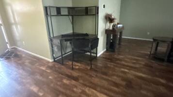 A room with a bunk bed, a desk, and a chair.
