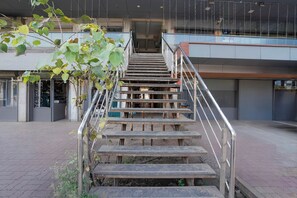 A staircase with metal railings leading to an entrance of a building.