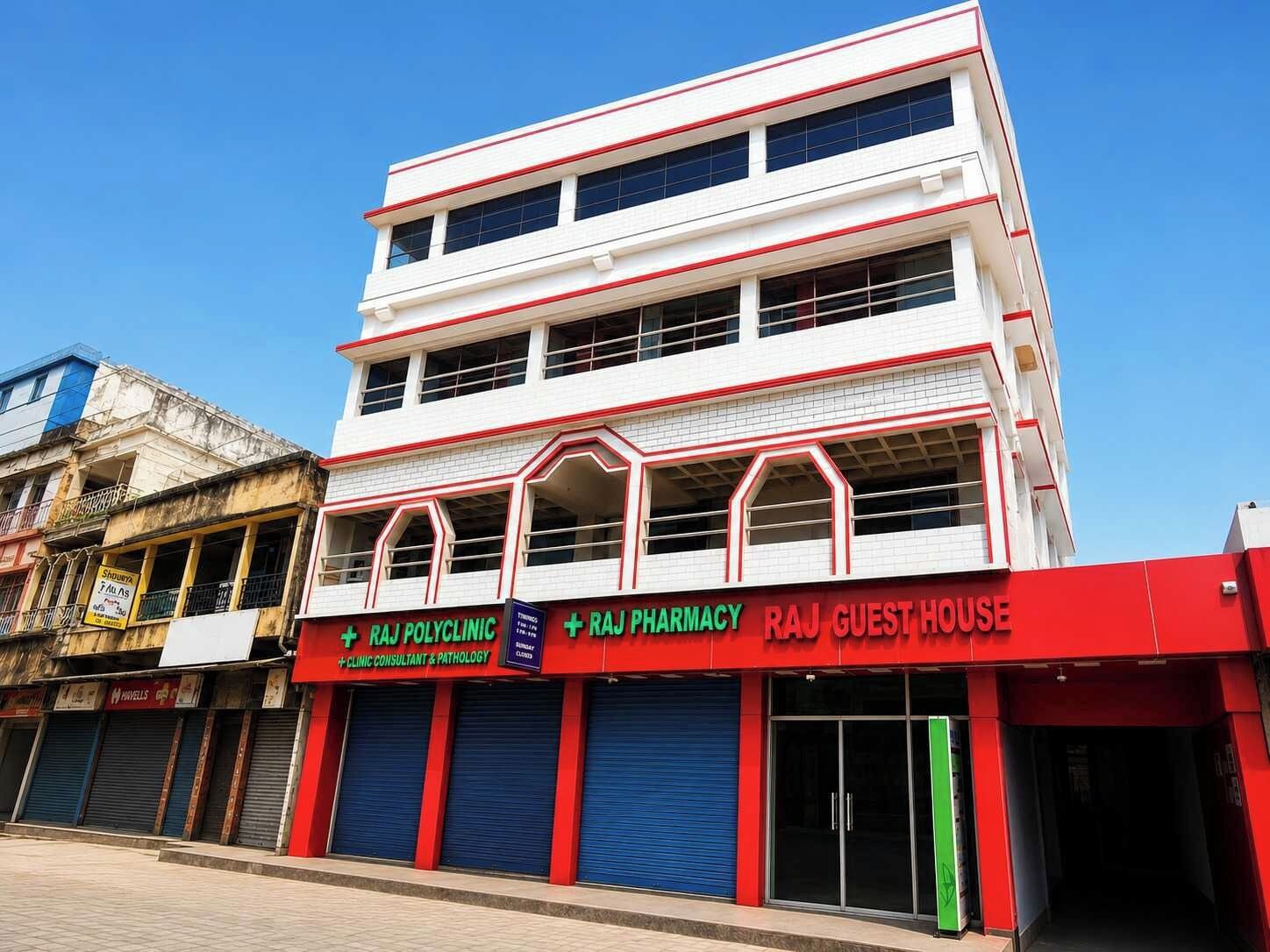A multi-story building with a pharmacy and guest house on the ground floor.