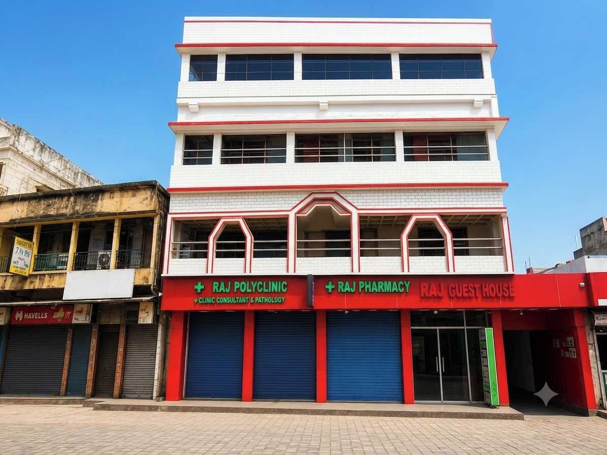 A multi-story building with signage for Raj Polyclinic and Raj Pharmacy on the ground floor.