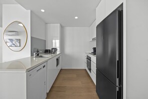 Fully equipped modern kitchen with plenty of space to prepare meals during your stay. - Walk to King St & RBWH | Parking (Bowen Hills)