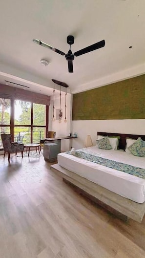 A bedroom with a bed, a ceiling fan, a desk, and a chair. - Wild Wadi Wilpattu (Eluwankulama)