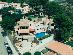 A multi-story villa with a swimming pool, surrounded by lush greenery and a hilly landscape. - "vista al Mar" Puerto Andratx (Andraitx)