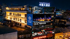 Un edificio de varios pisos con señalización para 'China Hotel' y 'City of Angels, Never Ending Brightness'.