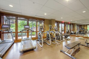 A gym with various exercise equipment including treadmills, elliptical machines, and stationary bikes. - Gondola to Skiing! Steamboat Condo w/ Hot Tubs (Steamboat Springs)