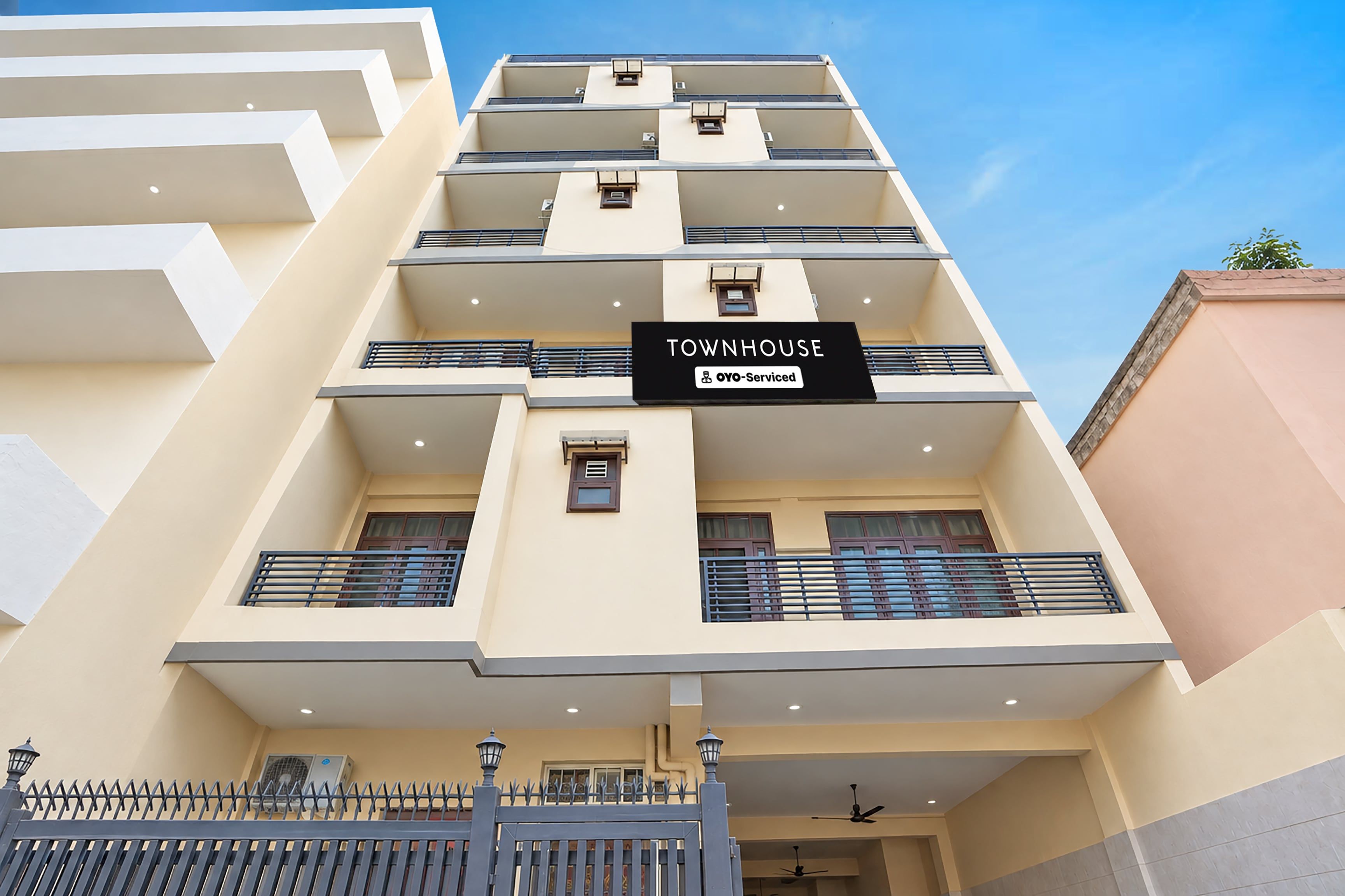 A multi-story building with a sign indicating it is serviced by OYO.